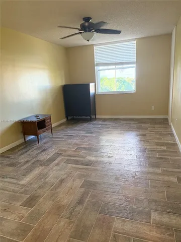 a view of room with window and wooden floor