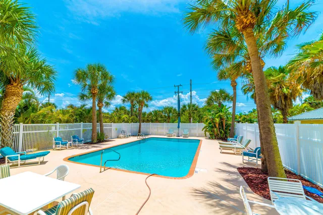 a view of a backyard with swimming pool