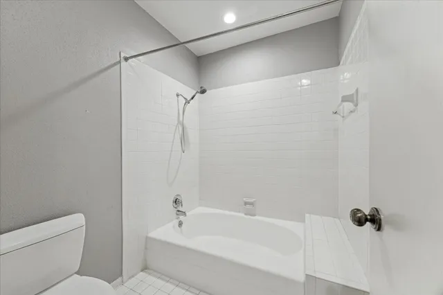 a bathroom with a bathtub and shower