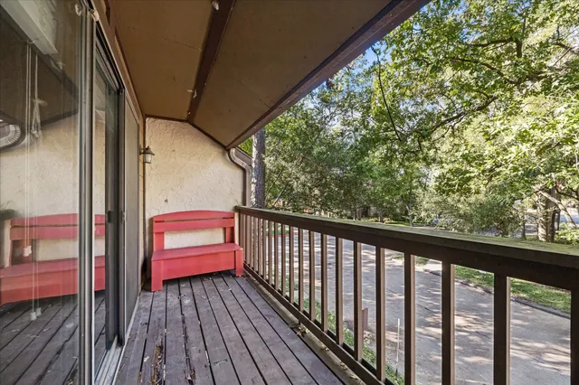 a balcony with wooden floor