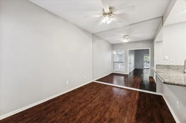 a view of kitchen and hall with wooden floor