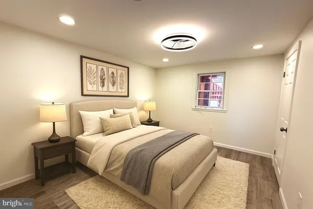 a bedroom with a bed and a painting