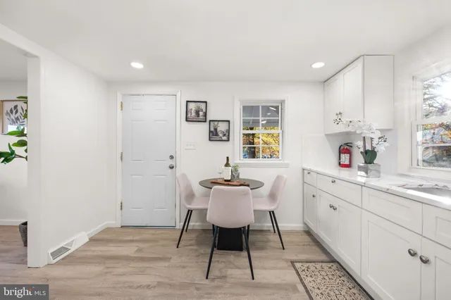 a kitchen with a sink cabinets and wooden floor
