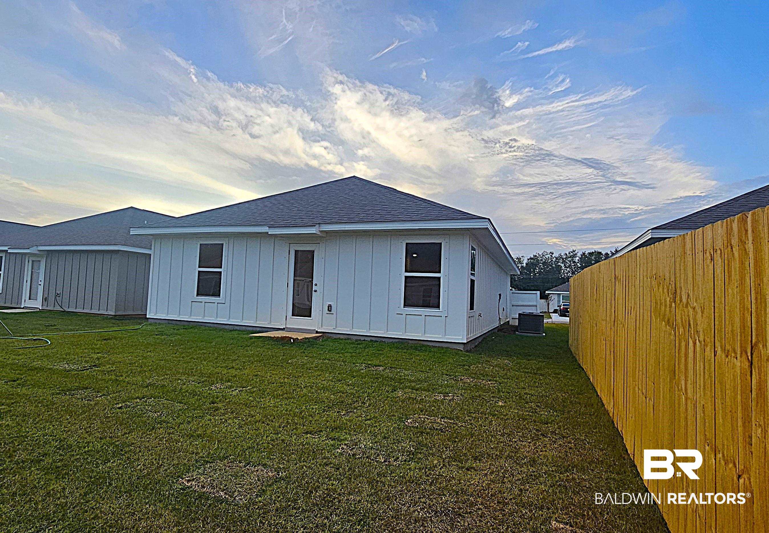 1148 Sweet Laurel Street Foley, AL 36535 - Photo 5 of 18 Rear view of house featuring a lawn and central AC unit