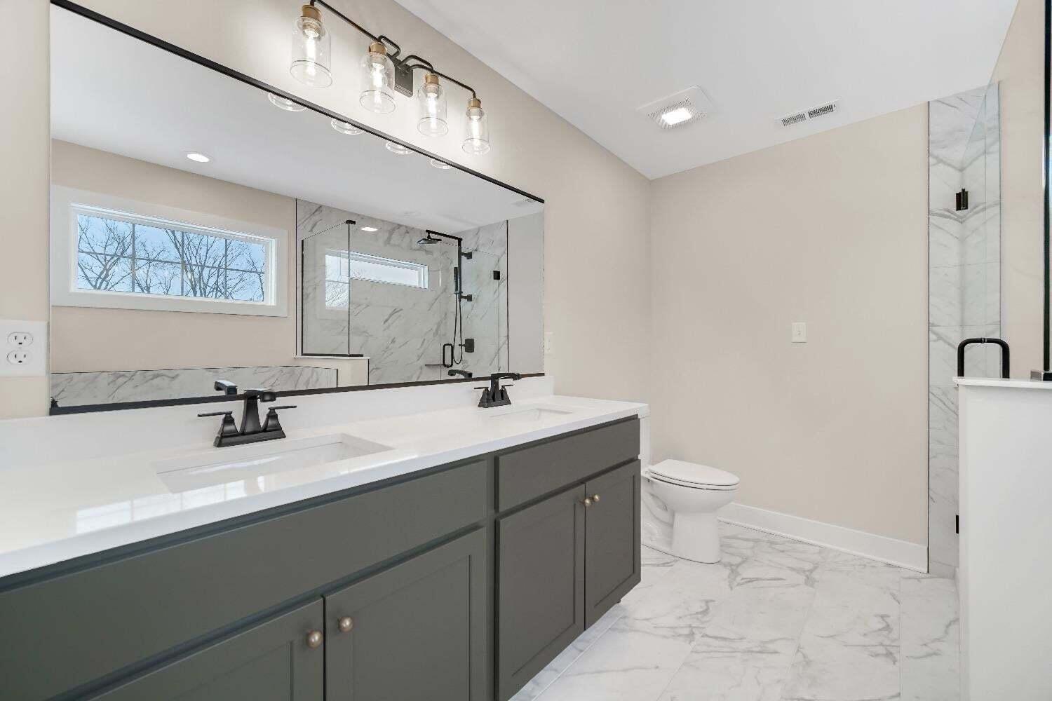 712 Verdano Terrace Crown Point, IN 46307 - Photo 17 of 24 a bathroom with a double vanity sink toilet and mirror