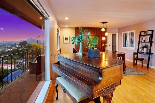 a dining room with furniture and wooden floor