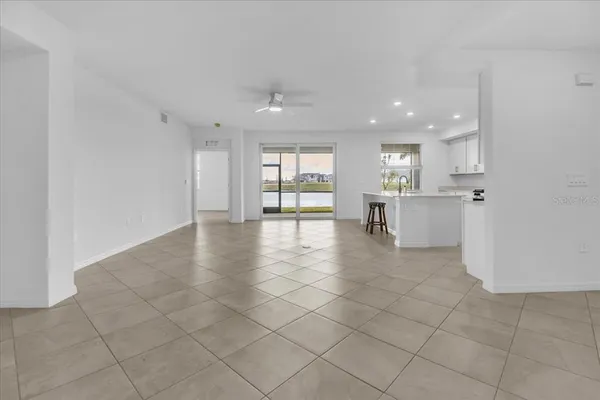 a kitchen with white cabinets and sink