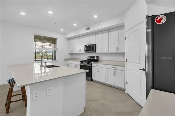 a kitchen with a sink and refrigerator
