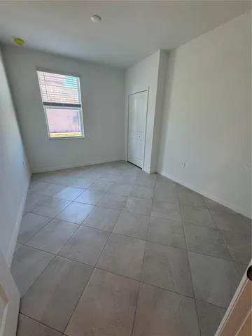 a view of a hallway with an empty room and door