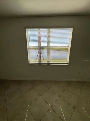 a view of entryway and kitchen with a sink