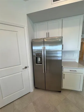 a kitchen with cabinets and stainless steel appliances