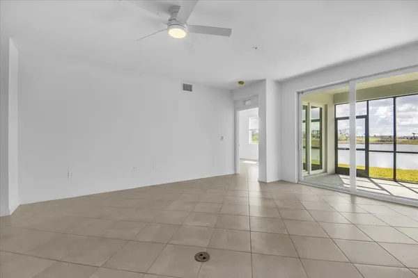 a view of kitchen with stainless steel appliances granite countertop a refrigerator and a stove top oven
