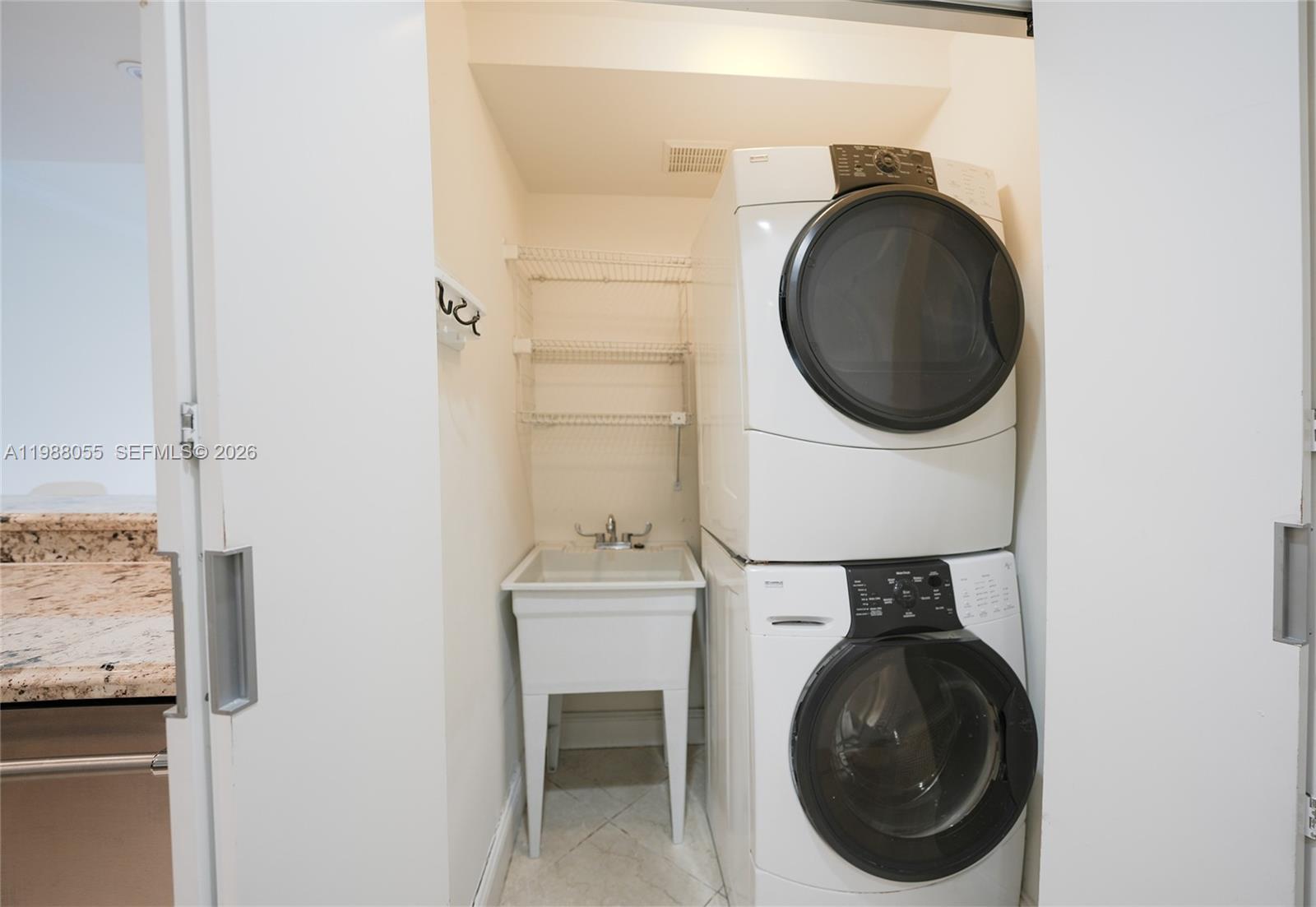 151 Crandon Boulevard, Unit 320 Key Biscayne, FL 33149 - Photo 6 of 10 a close view of a utility room with dryer and washer