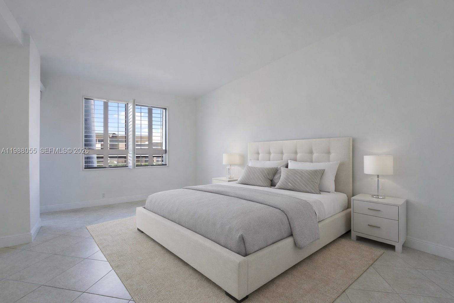151 Crandon Boulevard, Unit 320 Key Biscayne, FL 33149 - Photo 7 of 10 a bedroom with a bed and a window