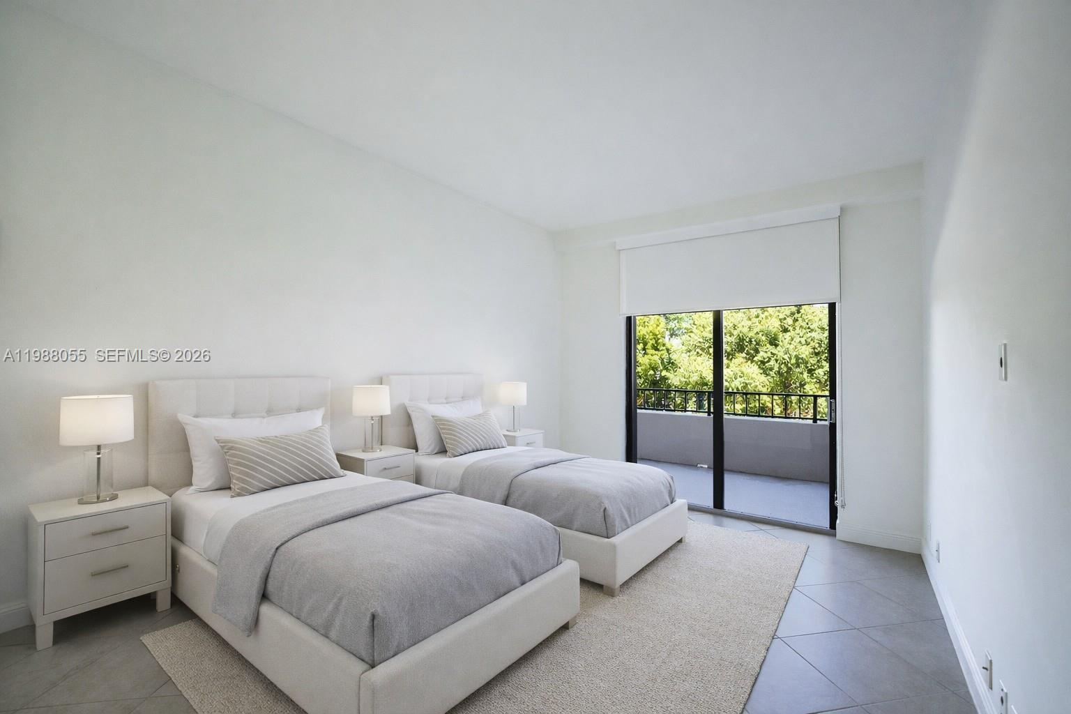151 Crandon Boulevard, Unit 320 Key Biscayne, FL 33149 - Photo 8 of 10 a bedroom with two beds and a large window