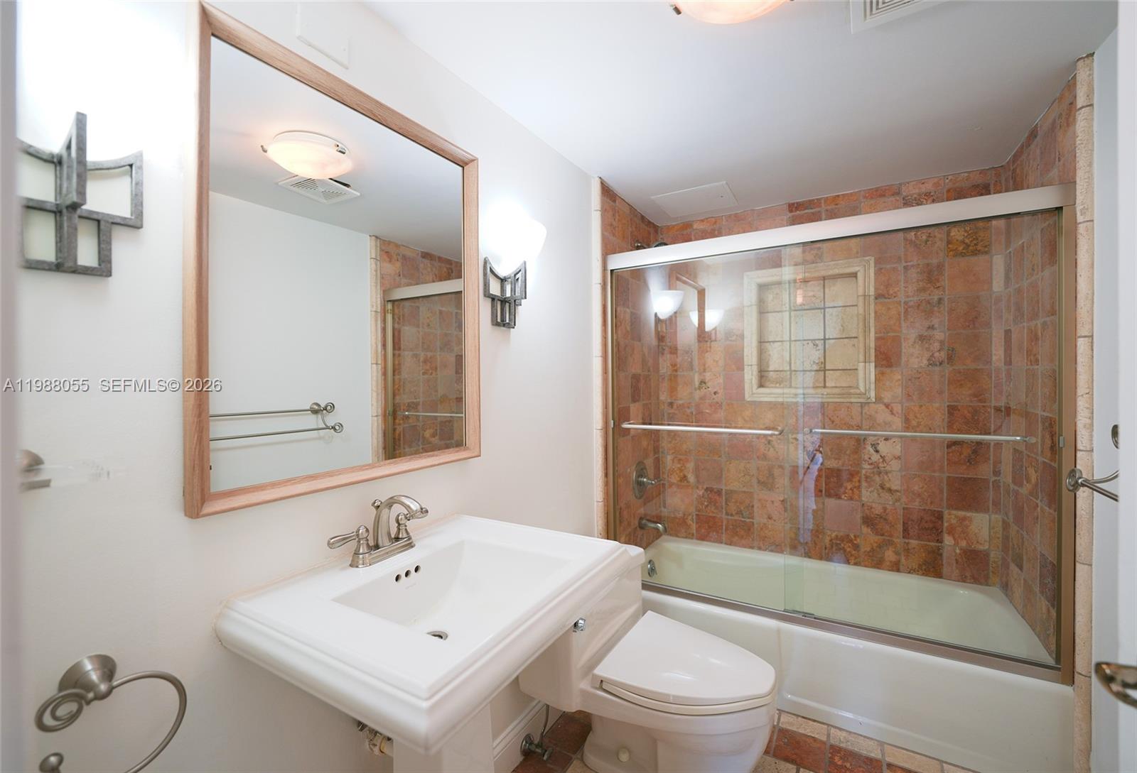 151 Crandon Boulevard, Unit 320 Key Biscayne, FL 33149 - Photo 9 of 10 a bathroom with a sink mirror toilet and shower