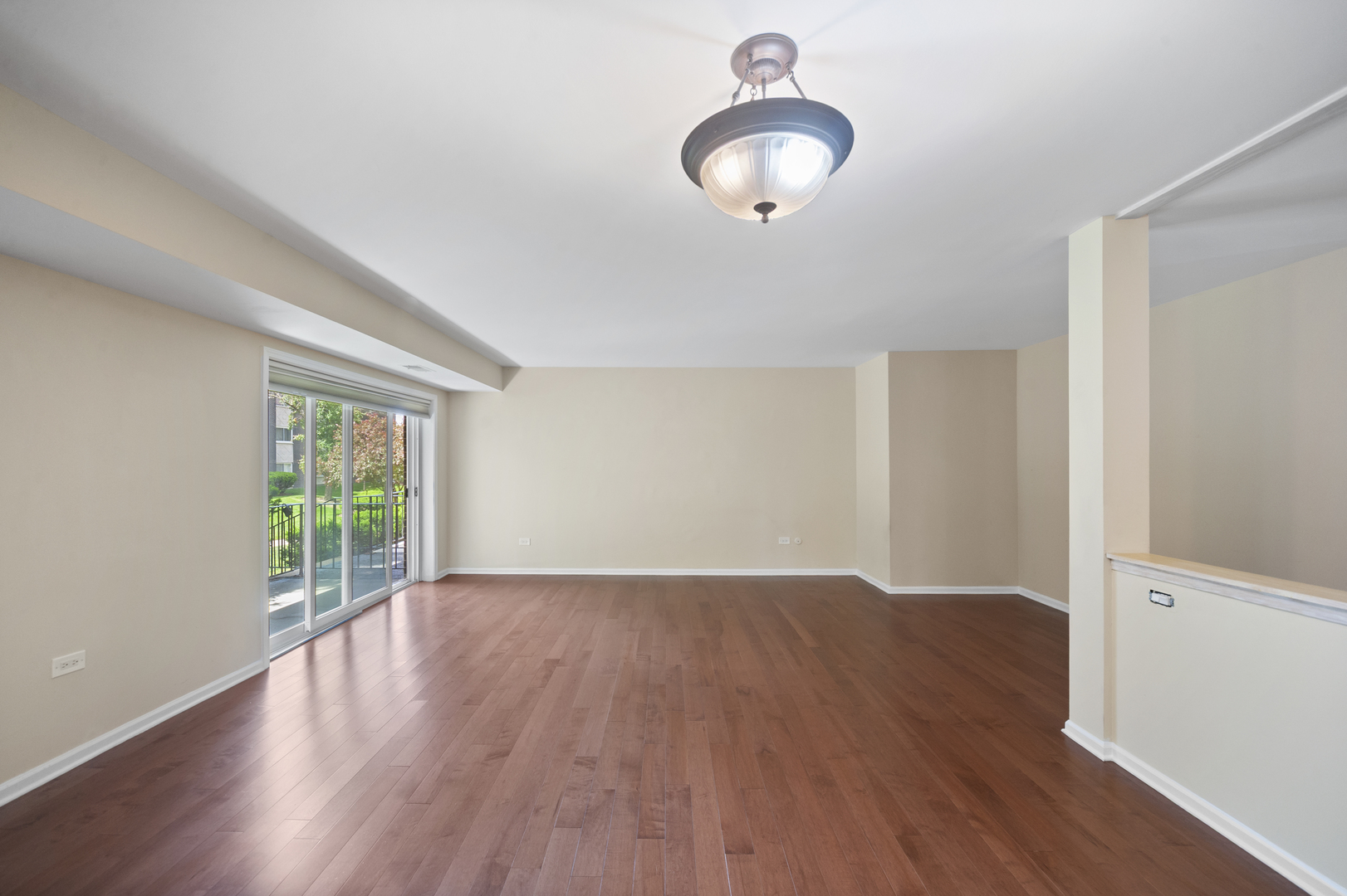 4949 Golf Road, Unit 101 Skokie, IL 60077 - Photo 18 of 22 an empty room with wooden floor and windows