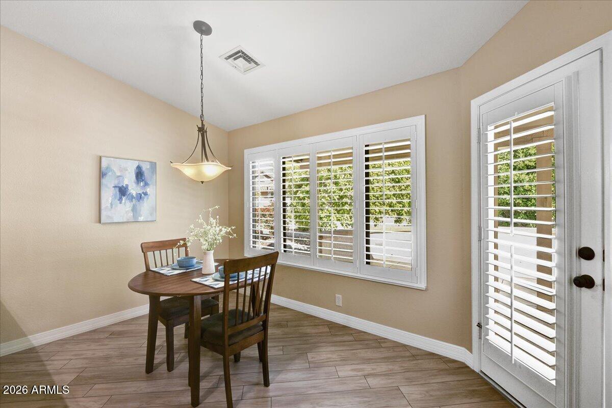 9136 West Rimrock Drive Peoria, AZ 85382 - Photo 11 of 25 a view of a dining room with furniture window and wooden floor