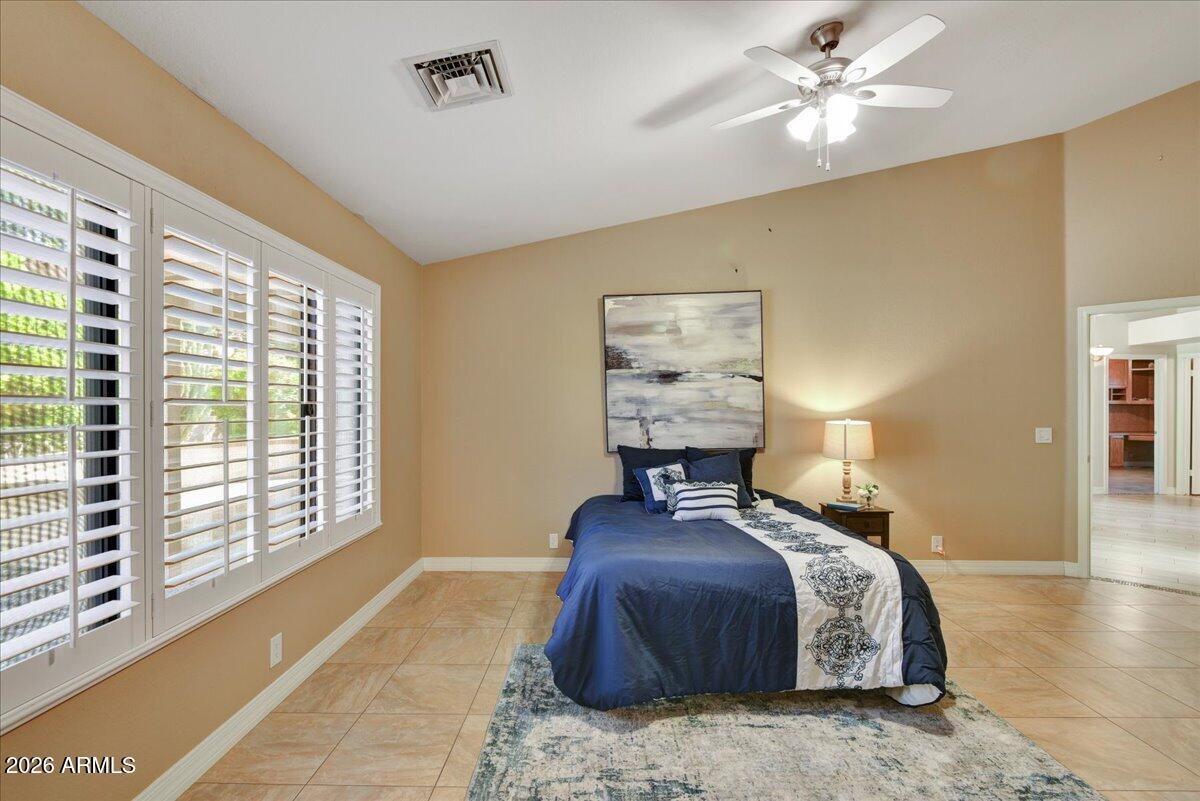9136 West Rimrock Drive Peoria, AZ 85382 - Photo 13 of 25 a bed room with a bed and a chandelier