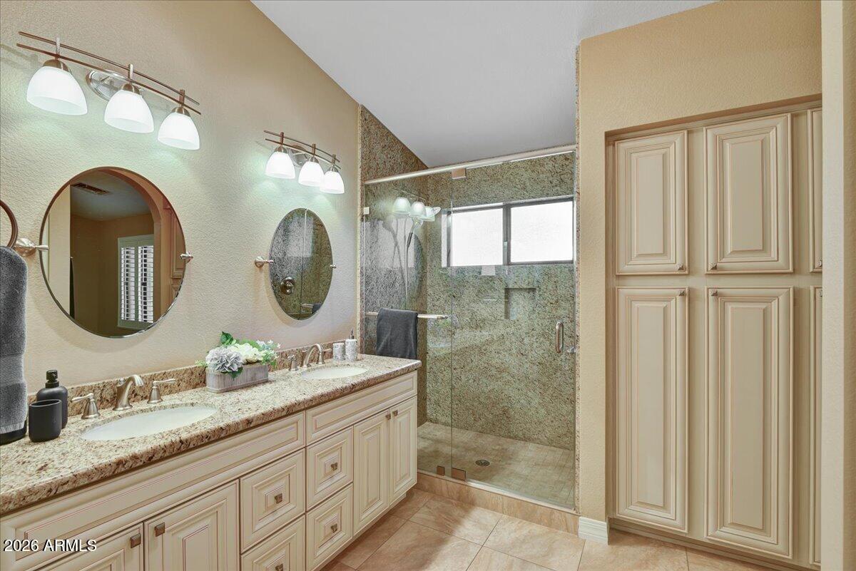 9136 West Rimrock Drive Peoria, AZ 85382 - Photo 14 of 25 a bathroom with a granite countertop double vanity sink and a mirror