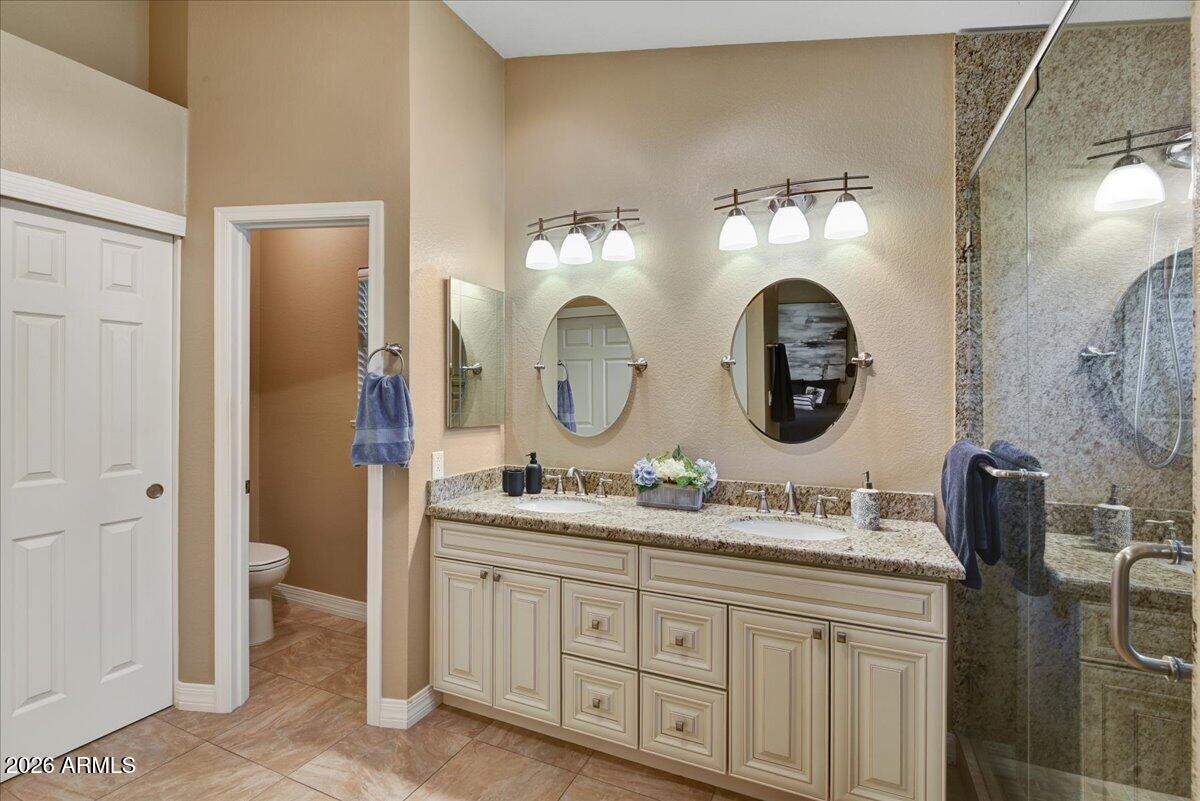 9136 West Rimrock Drive Peoria, AZ 85382 - Photo 15 of 25 a bathroom with a bathroom sink and a mirror