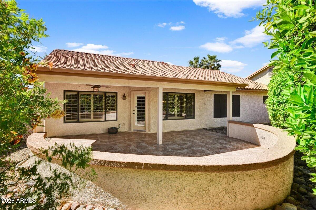 9136 West Rimrock Drive Peoria, AZ 85382 - Photo 22 of 25 a front view of a house with a garden