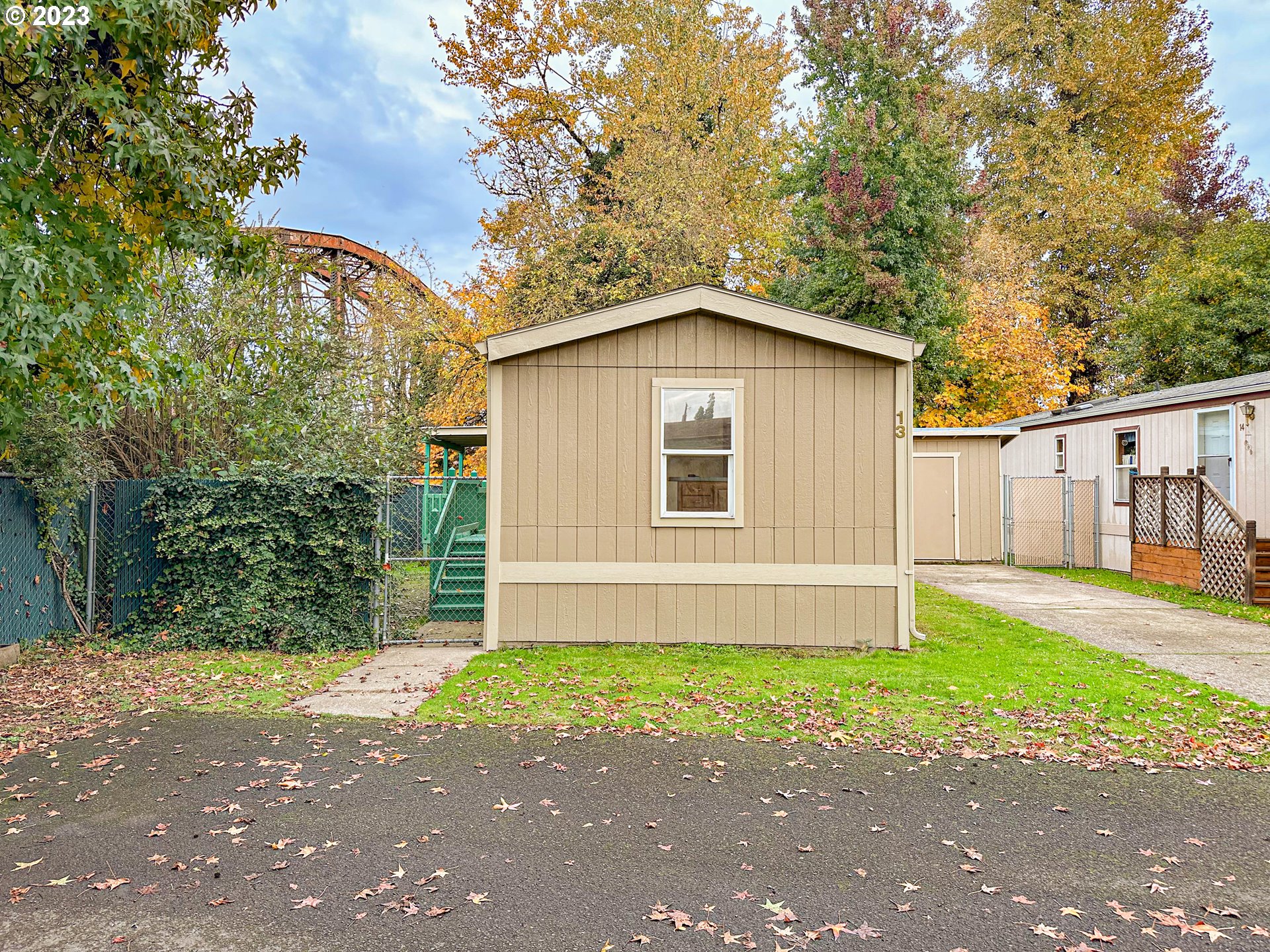 4475 Franklin Boulevard, Unit 13 Eugene, OR 97403 - Photo 22 of 22 a white house with a small yard and a large tree