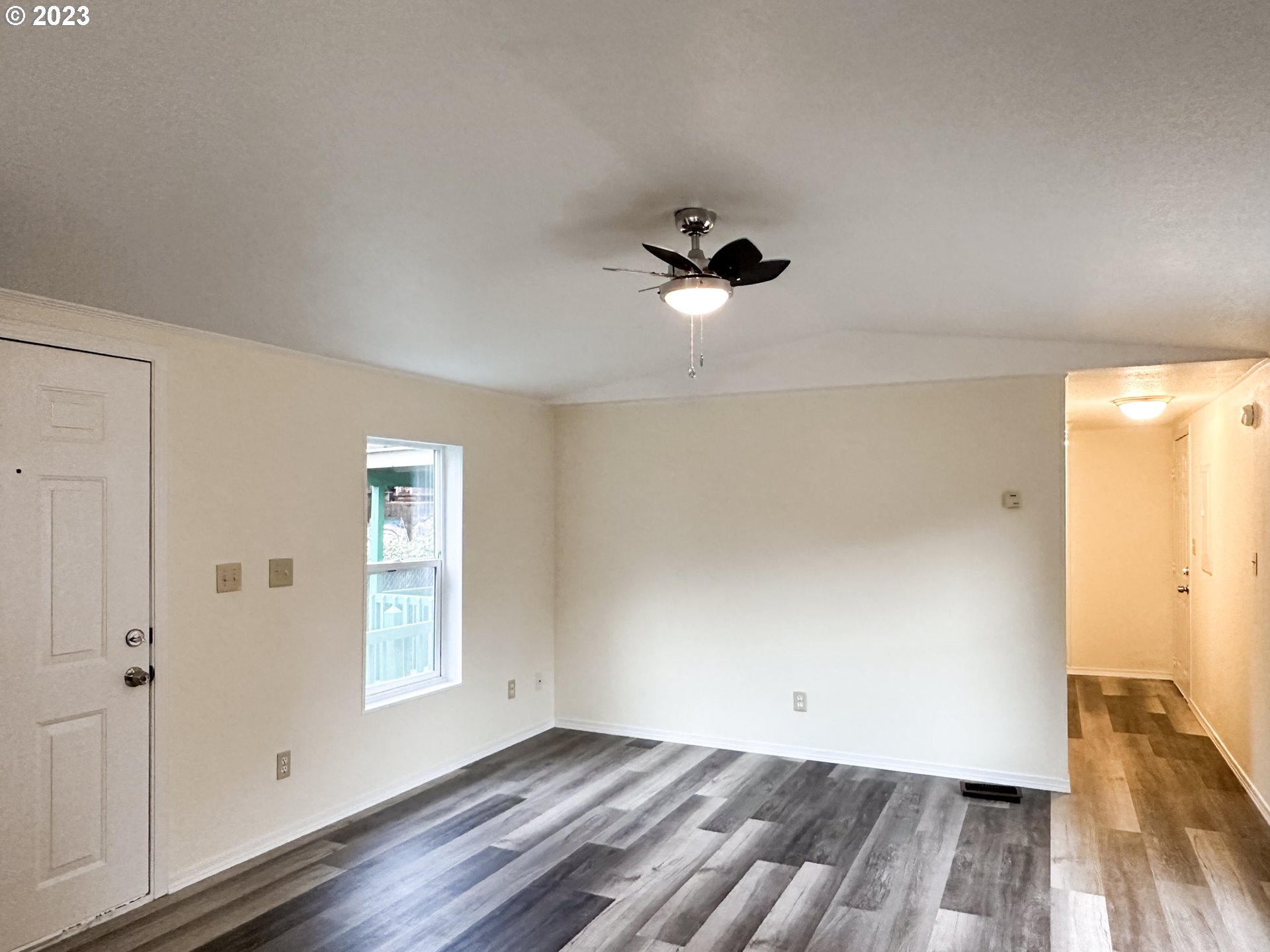 4475 Franklin Boulevard, Unit 13 Eugene, OR 97403 - Photo 3 of 22 wooden floor in an empty room with a window