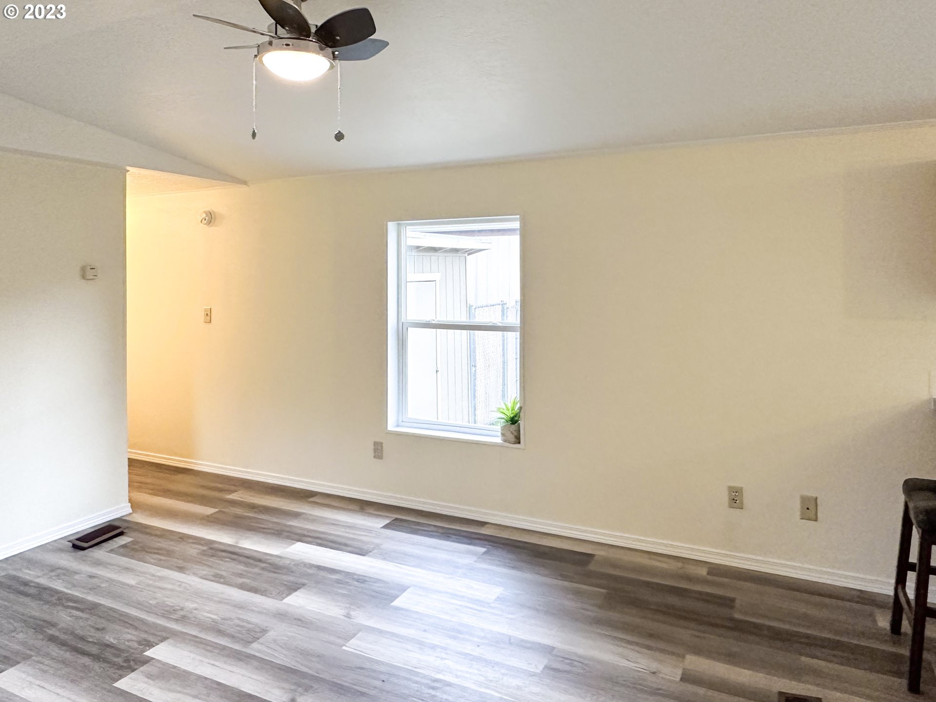 4475 Franklin Boulevard, Unit 13 Eugene, OR 97403 - Photo 4 of 22 an empty room with wooden floor fan and windows
