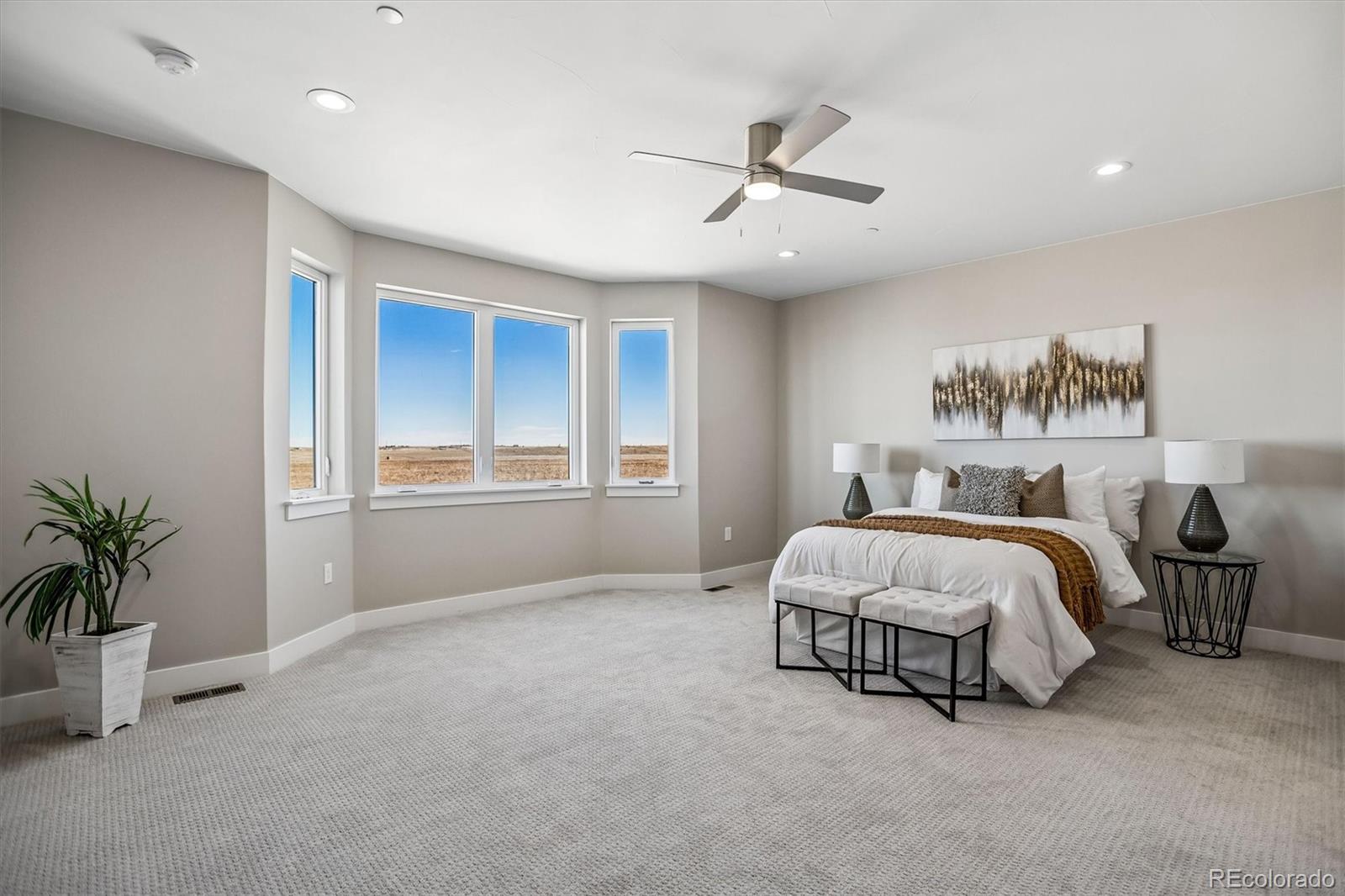 13350 Imboden Road Hudson, CO 80642 - Photo 17 of 50 a spacious bedroom with a bed and a chandelier