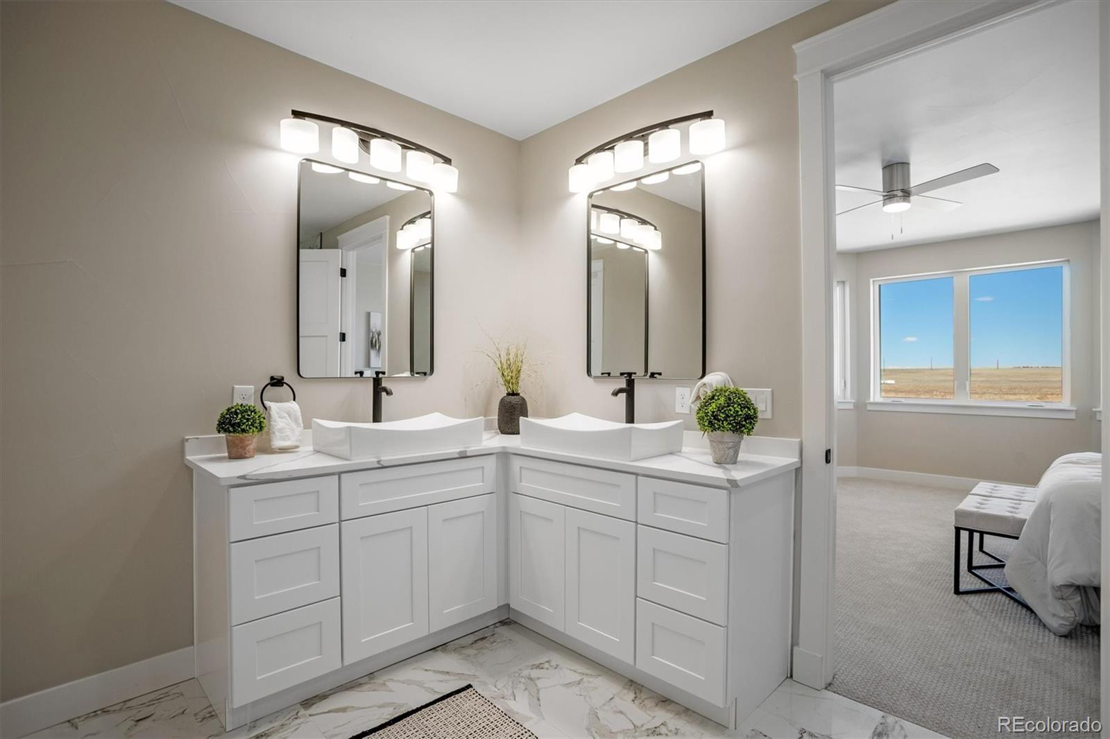 13350 Imboden Road Hudson, CO 80642 - Photo 19 of 50 a spacious bathroom with a double vanity sink and a mirror