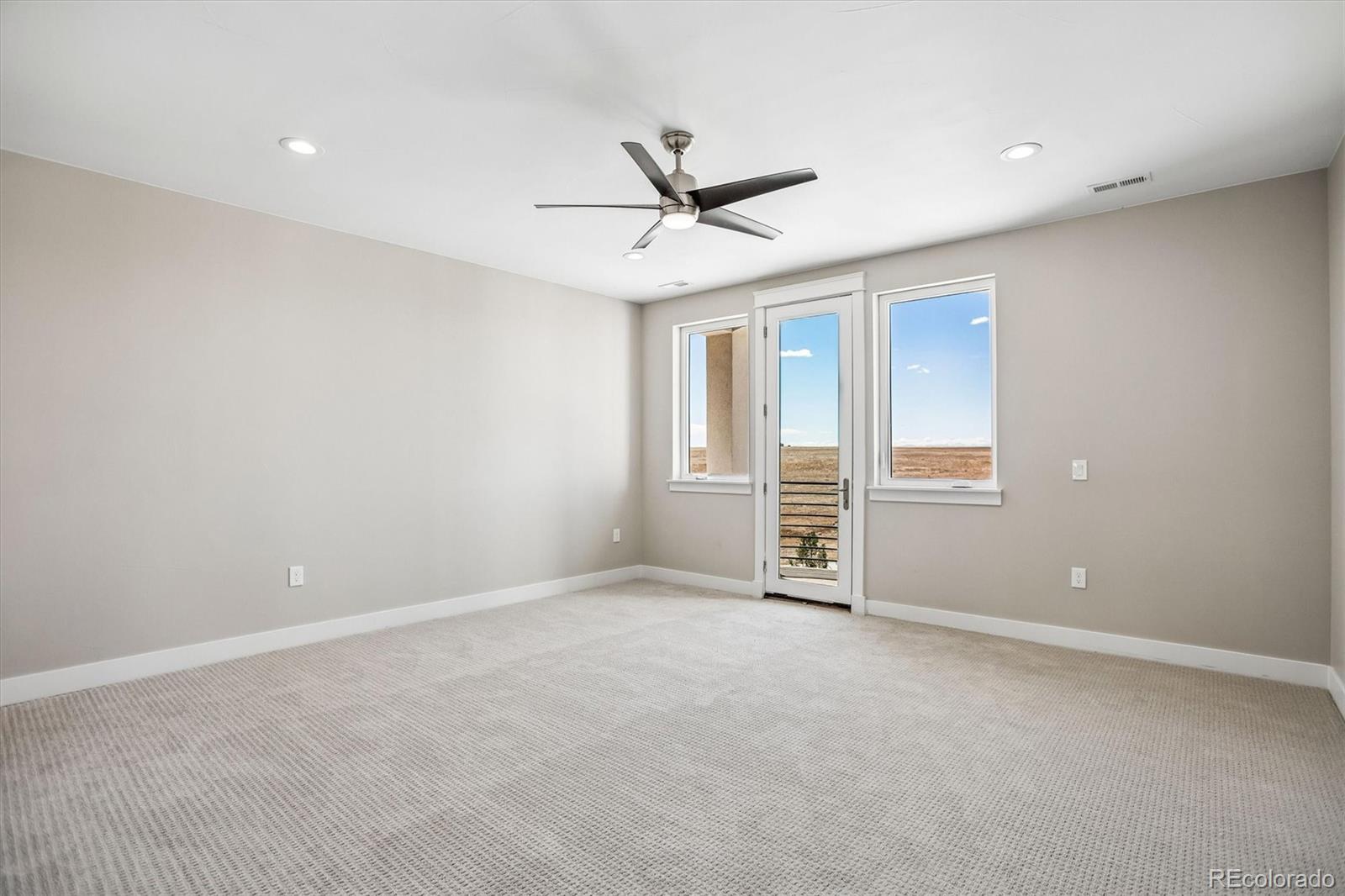 13350 Imboden Road Hudson, CO 80642 - Photo 31 of 50 an empty room with windows and ceiling fan