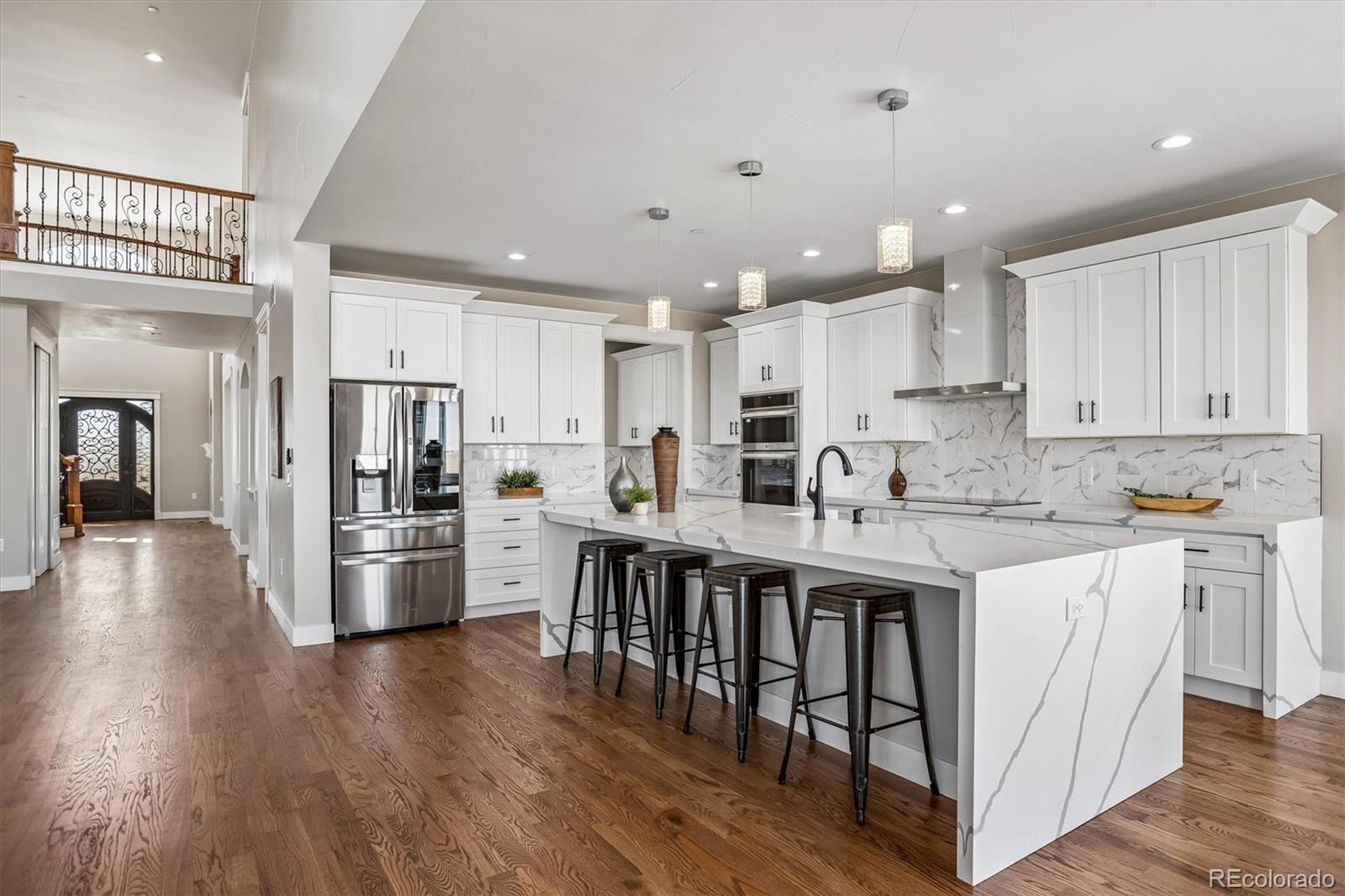 13350 Imboden Road Hudson, CO 80642 - Photo 8 of 50 a kitchen with stainless steel appliances kitchen island granite countertop a refrigerator and a stove top oven