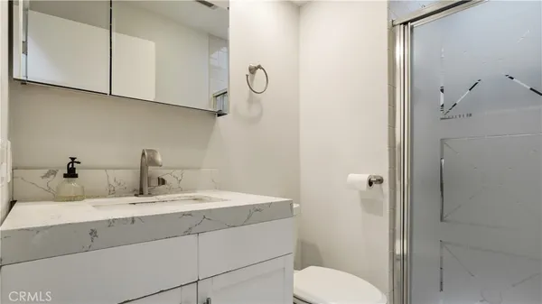 a bathroom with a sink toilet and shower