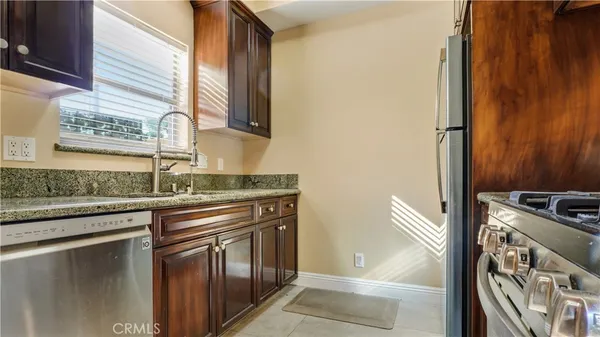 a kitchen with stainless steel appliances granite countertop a stove and a sink