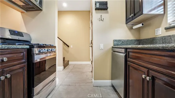a kitchen with stainless steel appliances granite countertop a refrigerator and a stove