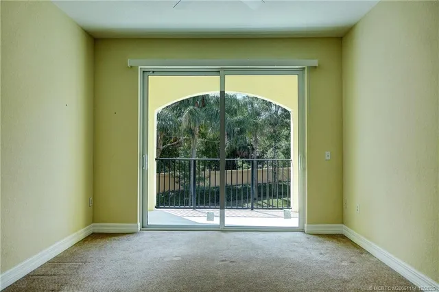a view of empty room with floor to ceiling window