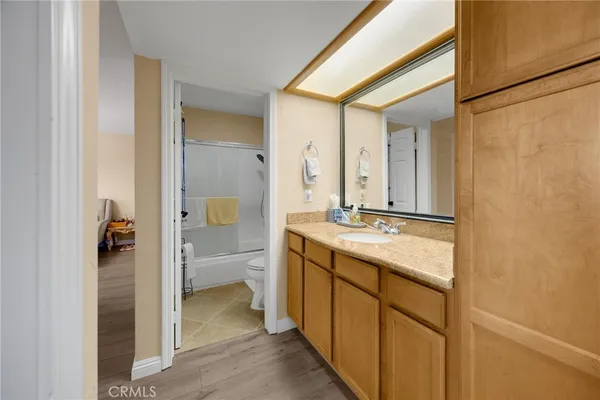 a bathroom with a granite countertop sink and a mirror