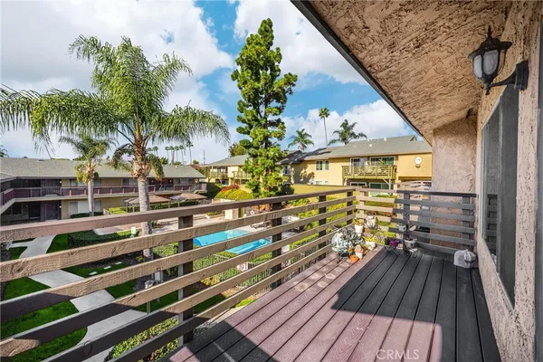 a view of a balcony with wooden floor and fence