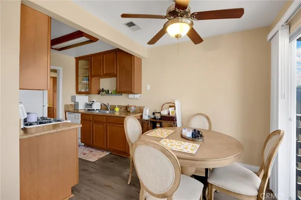 a kitchen with sink a stove and chairs