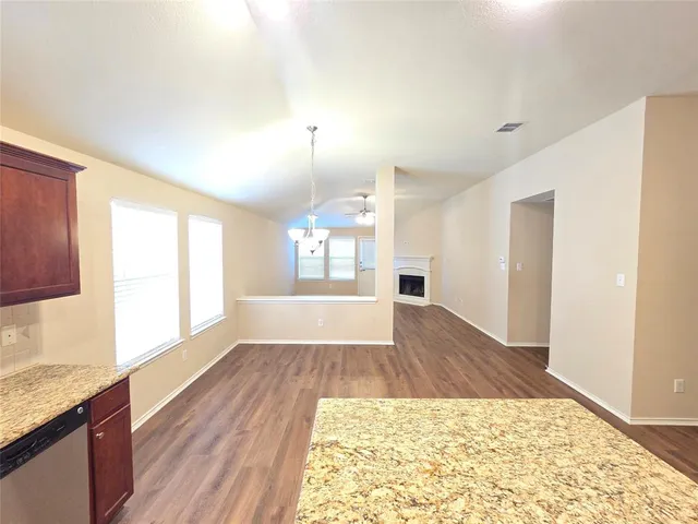 a kitchen with stainless steel appliances granite countertop a sink stove and microwave
