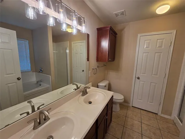 a bathroom with a glass shower door and sink