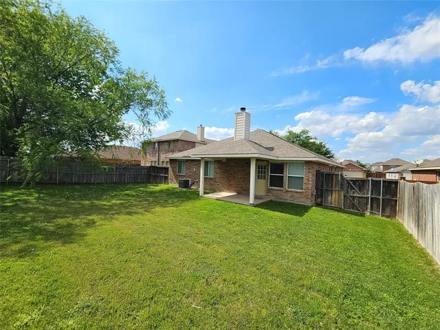 a view of a house with a backyard and a garden