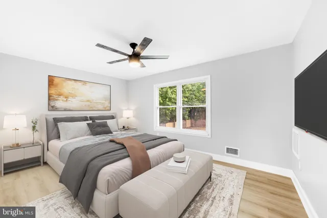 a bedroom with a large bed and a flat screen tv