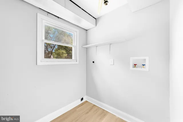 a view of room with window and wooden floor
