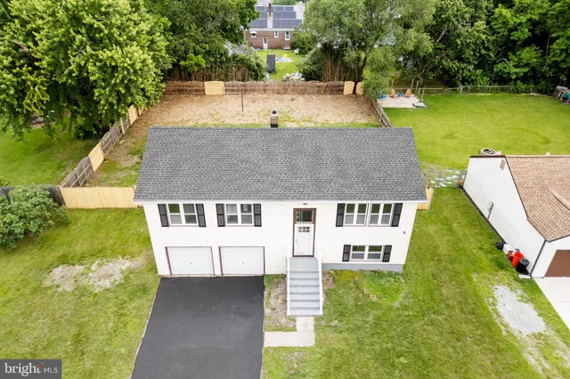 an aerial view of a house with swimming pool and garden