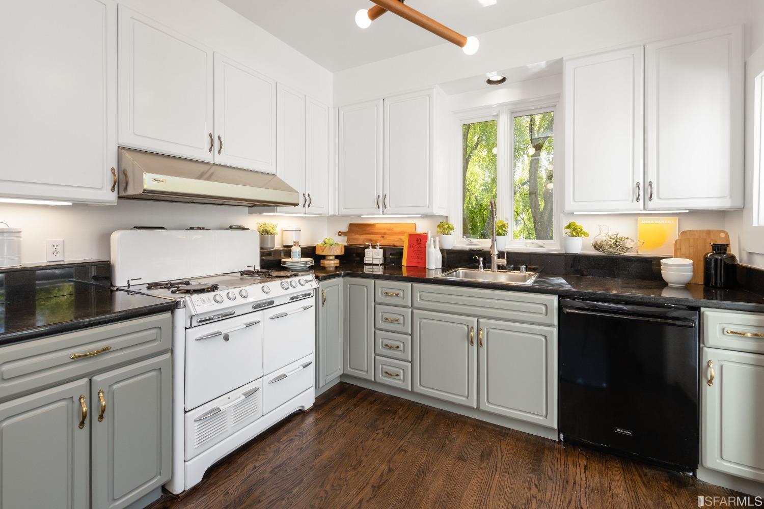 6th Avenue San Francisco, CA 94122 - Photo 15 of 72 a kitchen with granite countertop white cabinets and white appliances