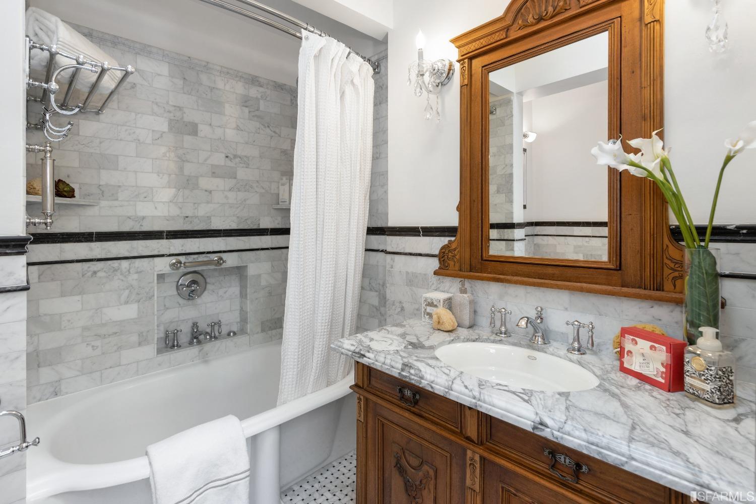 6th Avenue San Francisco, CA 94122 - Photo 26 of 72 a bathroom with a granite countertop sink a mirror a vanity and bathtub