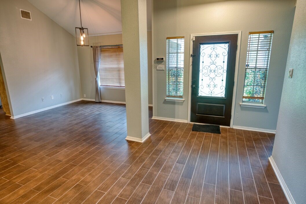 308 County Road 893B Angleton, TX 77515 - Photo 10 of 41 an empty room with wooden floor and a fireplace