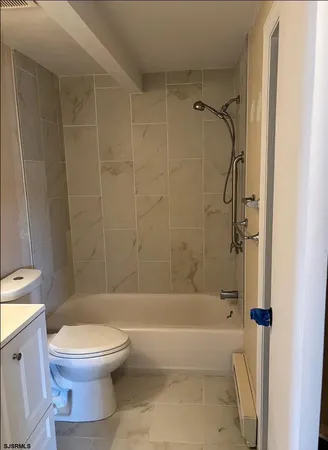 a bathroom with a toilet and a bathtub